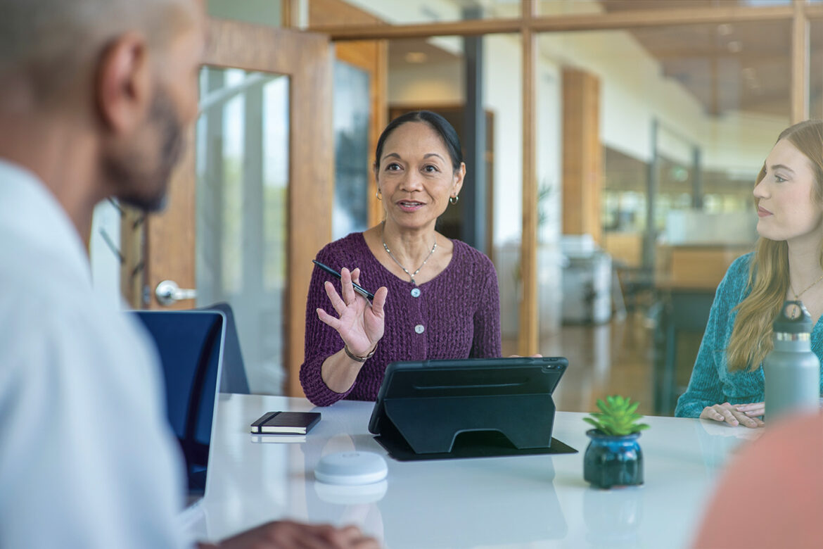 Female business owner discussing her strategy for getting a business loan with colleagues